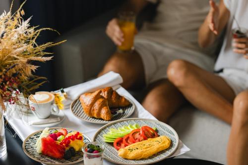 a table with three plates of food on it at Crowne Plaza Madrid - Centre Retiro by IHG in Madrid