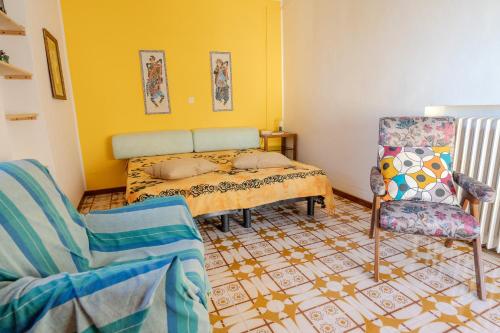 a living room with a bed and a chair at Casa di Nina in Pretoro