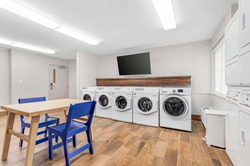 a laundry room with a table and washing machines at Sonesta Simply Suites Baltimore BWI Airport in Linthicum Heights