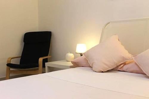 a bedroom with a bed and a black chair at La Villa in Salve