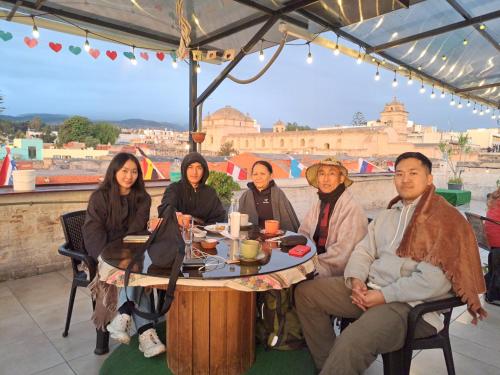 a group of people sitting at a table with a view at Holistic Scandinavia House in Arequipa