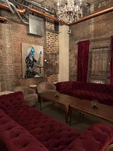 a room with red couches and a painting on the wall at Hotel Petersburg, Tapestry Collection By Hilton in Petersburg