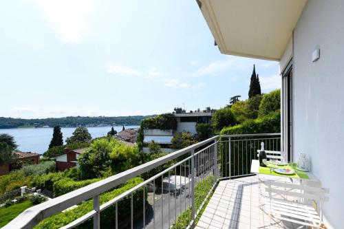 a balcony with a view of the water at Openspace Sunrise lake view in Salò