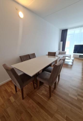 a white dining room with a table and chairs at Two storey apart Most beautiful location in Copenhagen in Copenhagen