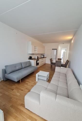 a living room with a white couch and a table at Two storey apart Most beautiful location in Copenhagen in Copenhagen