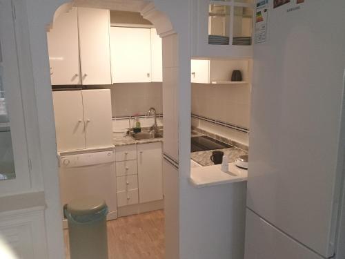 a kitchen with white cabinets and a sink at Tranquilo Townhouse Casa Spain Kwintos in Torrevieja
