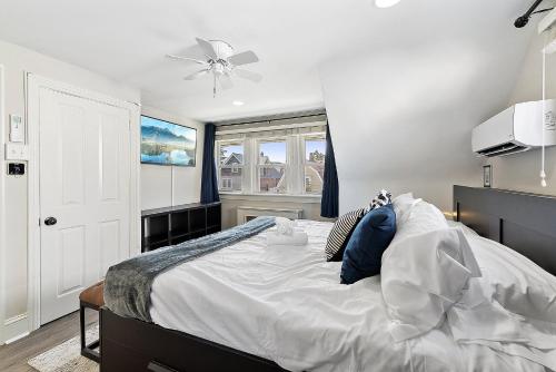 a bedroom with a large bed with blue pillows at Main Line Manor 3BR with King Beds & Patio & Backyard in Bryn Mawr