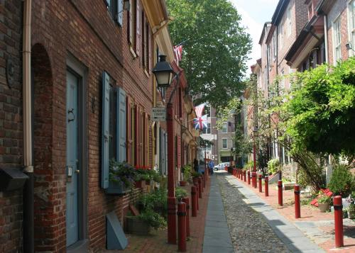 a cobblestone street in a city with buildings at Main Line Manor 3BR with King Beds & Patio & Backyard in Bryn Mawr