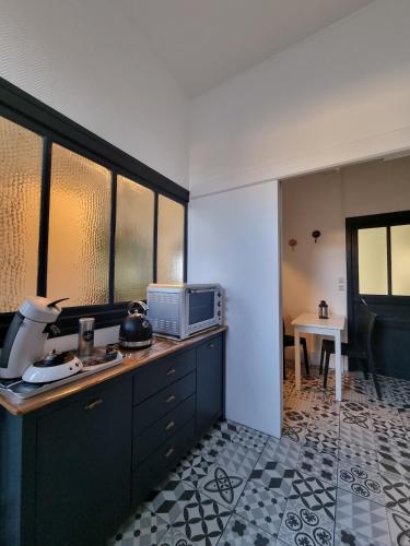 une cuisine avec un comptoir avec un micro-ondes dessus dans l'établissement Logement indépendant Sacré Coeur, à Cholet