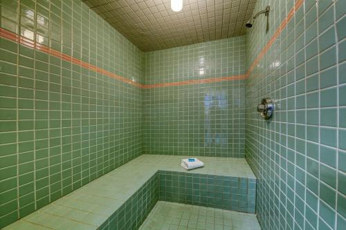 a green tiled bathroom with a tub with a scale at Marble Canyon in Fairmont Hot Springs