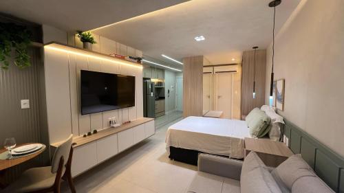 a bedroom with a bed and a tv and a couch at ArtStudio Open Spaces in Salvador