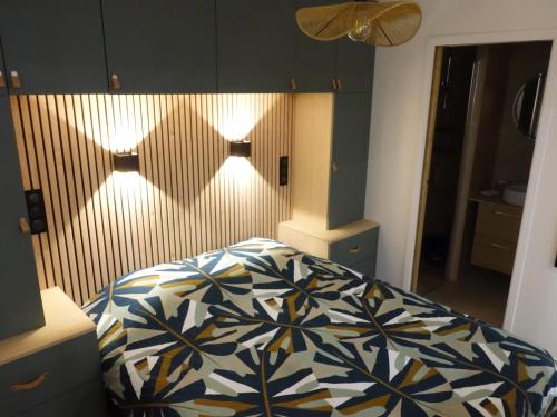 une chambre avec un lit avec une couette bleue et blanche dans l'établissement Appartement cosy - proximité rue du Commerce, à Paris