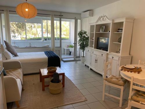 a bedroom with a bed and a living room at Casa Ligia in Vilamoura