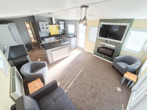 an overhead view of a living room with a couch and a tv at Whitstable Beaumont - Sleeps 6, 588 ft in Seasalter