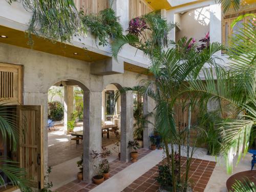 a courtyard with potted plants in a building at El Mambo Boutique Hotel in Las Terrenas