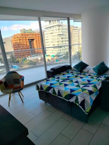 a bedroom with a bed and a large window at Lovely View Studio Building Heated Pool Gym Turco WIFI in Quito