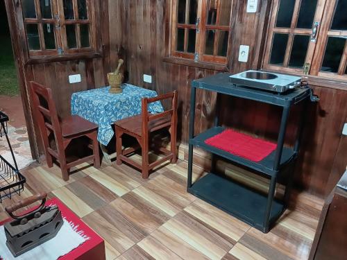 a table and chairs and a table and a table and a table at 2 Cabañas Para Parejas Con Baño Privado y 3 Cabañas en Bungalow Para 4 Personas Cada Una Con Baño Compartido in Itauguá