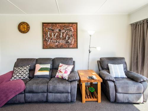 a living room with two chairs and a couch at Tasman Haven - Motueka Holiday Home in Motueka