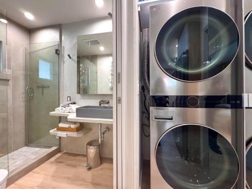 a bathroom with a stainless steel washer and dryer at Titus Retreat in San Diego