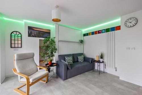 a waiting room with a couch and a clock at Substantial 5 bedroom townhouse with disabled access apartment, private off road parking space with EV point from 15th April 26, jaccuzi bath, Netflix and Wifi, near Argyle, boutique shops eateries and pubs in Plymouth