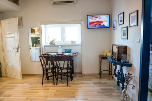 a dining room with a table and chairs and a window at Loreto LYA SEA VIEW APARTMENTS in Rovinj