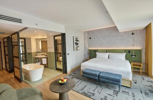 a hotel room with a bed and a bath tub at Hotel Indigo Lima Miraflores by IHG in Lima