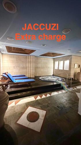a room with two beds and a sign on the ceiling at Paphos gardens studio suite in Paphos City