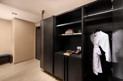 a room with a black closet with a white robe at Nobu Hotel Atlanta in Atlanta