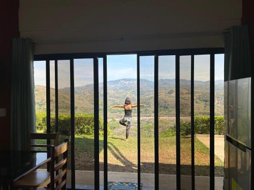 a woman jumping in the air on a skateboard in front of a window at Conectar con la naturaleza in Esparza