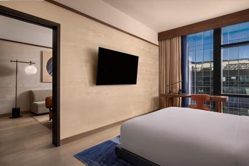 a bedroom with a bed and a tv on the wall at Nobu Hotel Atlanta in Atlanta
