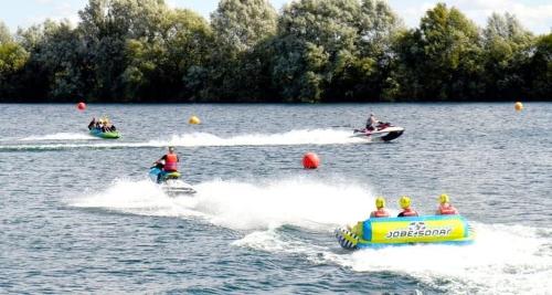 a group of people on boats in the water at Lakeside Retreat - AGH Hot Tub Breaks - Tattershall Lakes in Tattershall