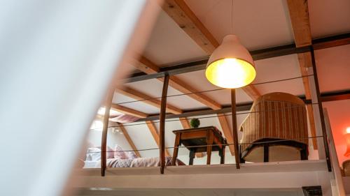a room with a mirror and a chair and a lamp at Loreto LYA SEA VIEW APARTMENTS in Rovinj