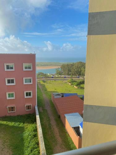 a pink building with a view of a body of water at Dar Assalam in Oualidia