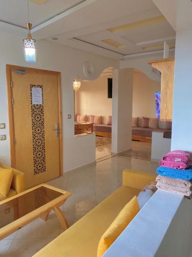 a living room with a couch and a table at Dar Assalam in Oualidia