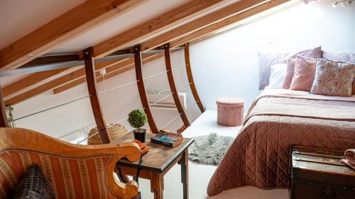 a bedroom with a bed and a table with a chair at Loreto LYA SEA VIEW APARTMENTS in Rovinj