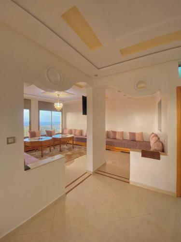 a living room with a couch and a table at Dar Assalam in Oualidia