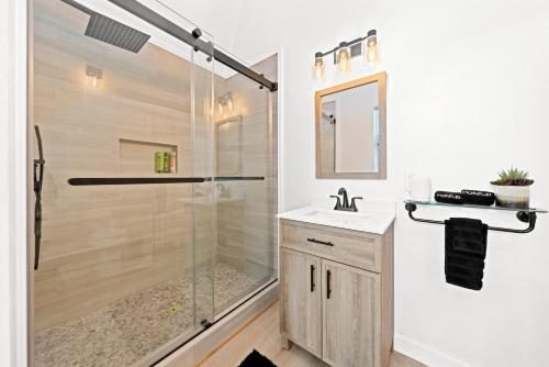 a bathroom with a shower and a sink at Ceto Treehouse Hottub Fredericksburg Romantic EV in Fredericksburg