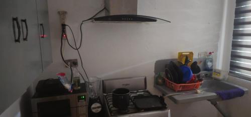a small kitchen with a stove and a sink at Habitacion in Monterrey