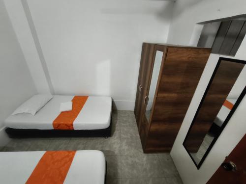 a small room with a bed and a door at Cabaña Gaia Rodadero in Santa Marta