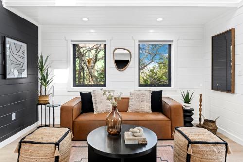 a living room with a couch and a table at Ares Treehouse Romantic Hottub Fredericksburg EV in Fredericksburg