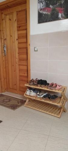 a room with wooden shelves with shoes in front of a door at Dar Assalam in Oualidia