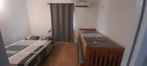 a small room with two beds and a curtain at Avenida colon in Santiago del Estero