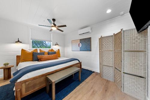 a bedroom with a bed and a ceiling fan at Apate Treehouse Lux Hot tub Fredericksburg EV BBQ in Fredericksburg