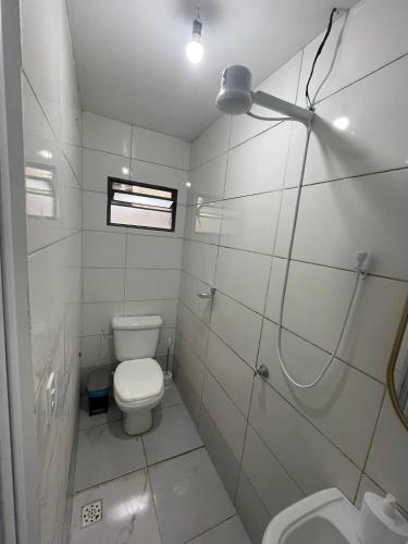 a white bathroom with a toilet and a sink at Flat J&C próx Praia da graciosa e UFT e Unitins in Palmas