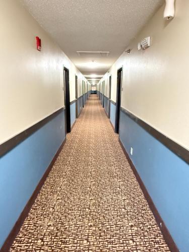 a corridor of an empty hospital hallway at Super 8 by Wyndham Reedsburg in Reedsburg