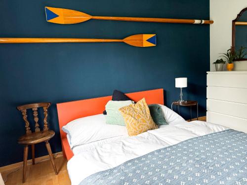 un letto con testiera arancione e parete blu di Lake Life a Sankt Gilgen