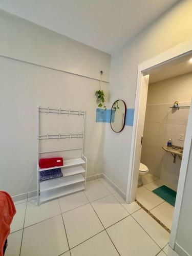 a bathroom with a shower and a toilet and a mirror at Desativado in São Luís