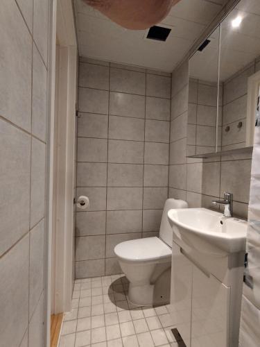 a bathroom with a toilet and a sink at MYROOM in Stroomi beach area in Tallinn