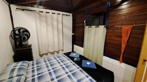 Ένα ή περισσότερα κρεβάτια σε δωμάτιο στο Pousada Residência Balestra