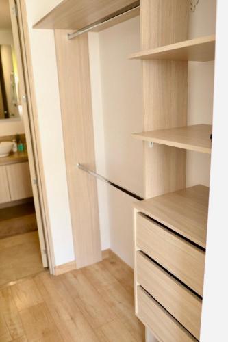 a closet with wooden shelves and a door at Wonderful place in Usaquen! in Bogotá